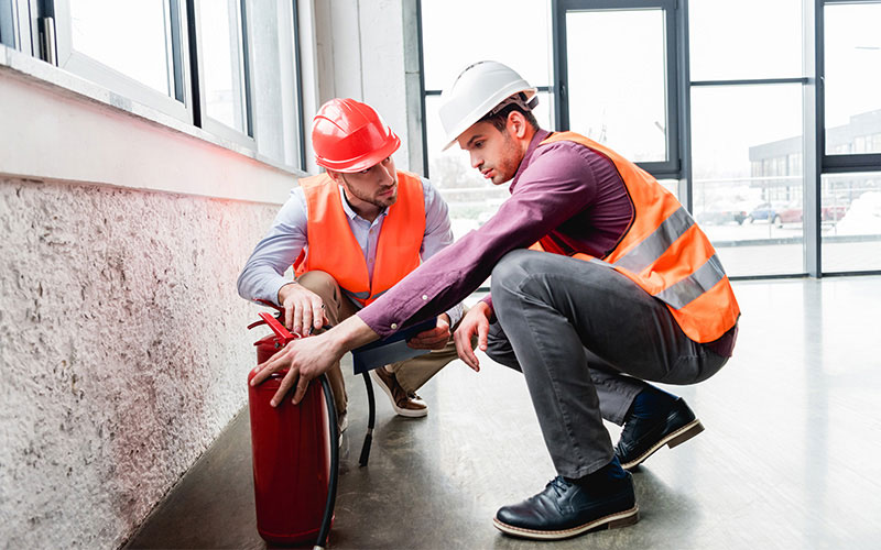 Two Men Working with Hard Hats and Safety Vests