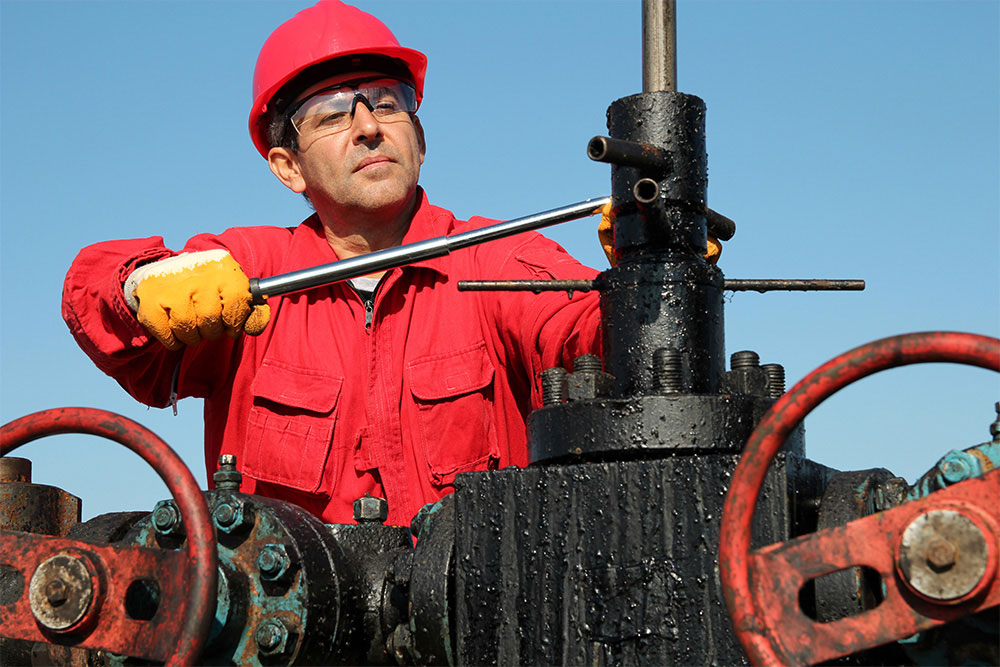 Man Working Wearing Hard Hat and Safety Glasses